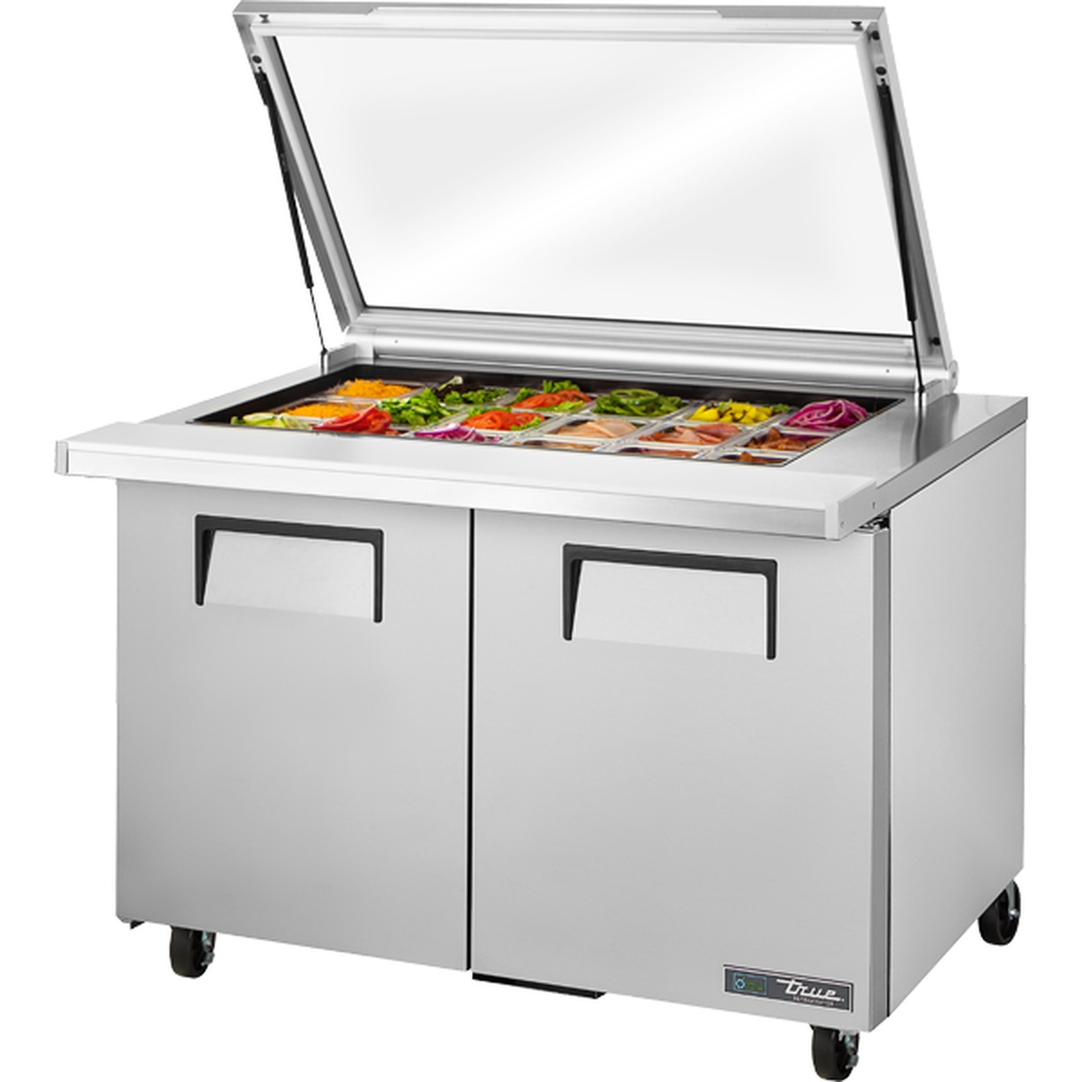 True TSSU-48-18M-B-FGLID-HC 48-inch mega top sandwich prep table with flat glass lid open, showing 18 food pans loaded with fresh ingredients and two stainless steel doors below