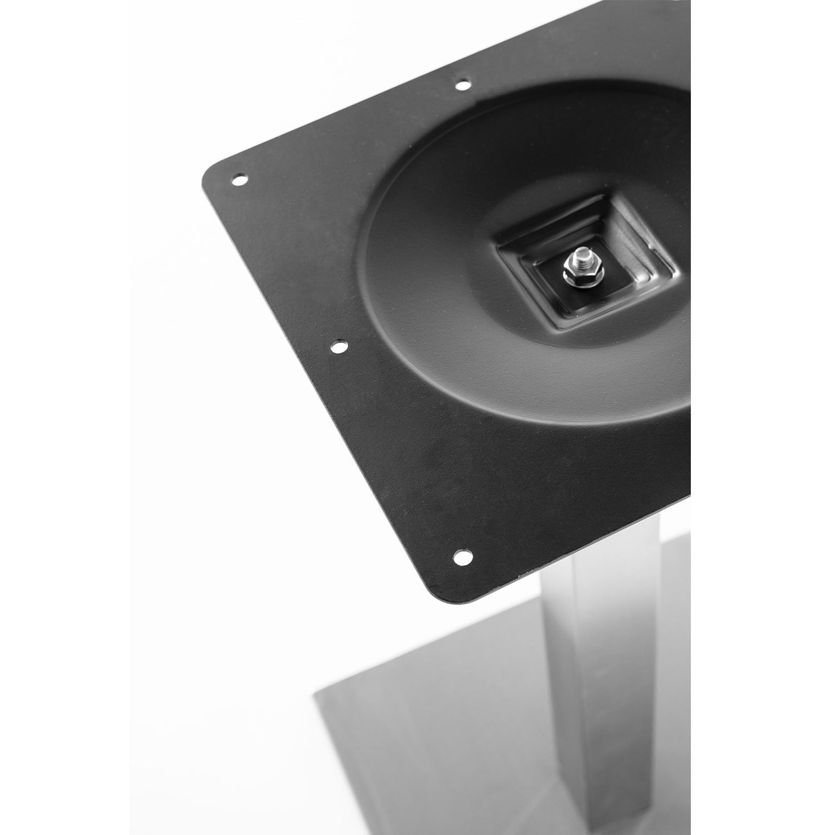 Close-up of the Gamma table base top mounting plate showing central bolt hardware and corner mounting holes