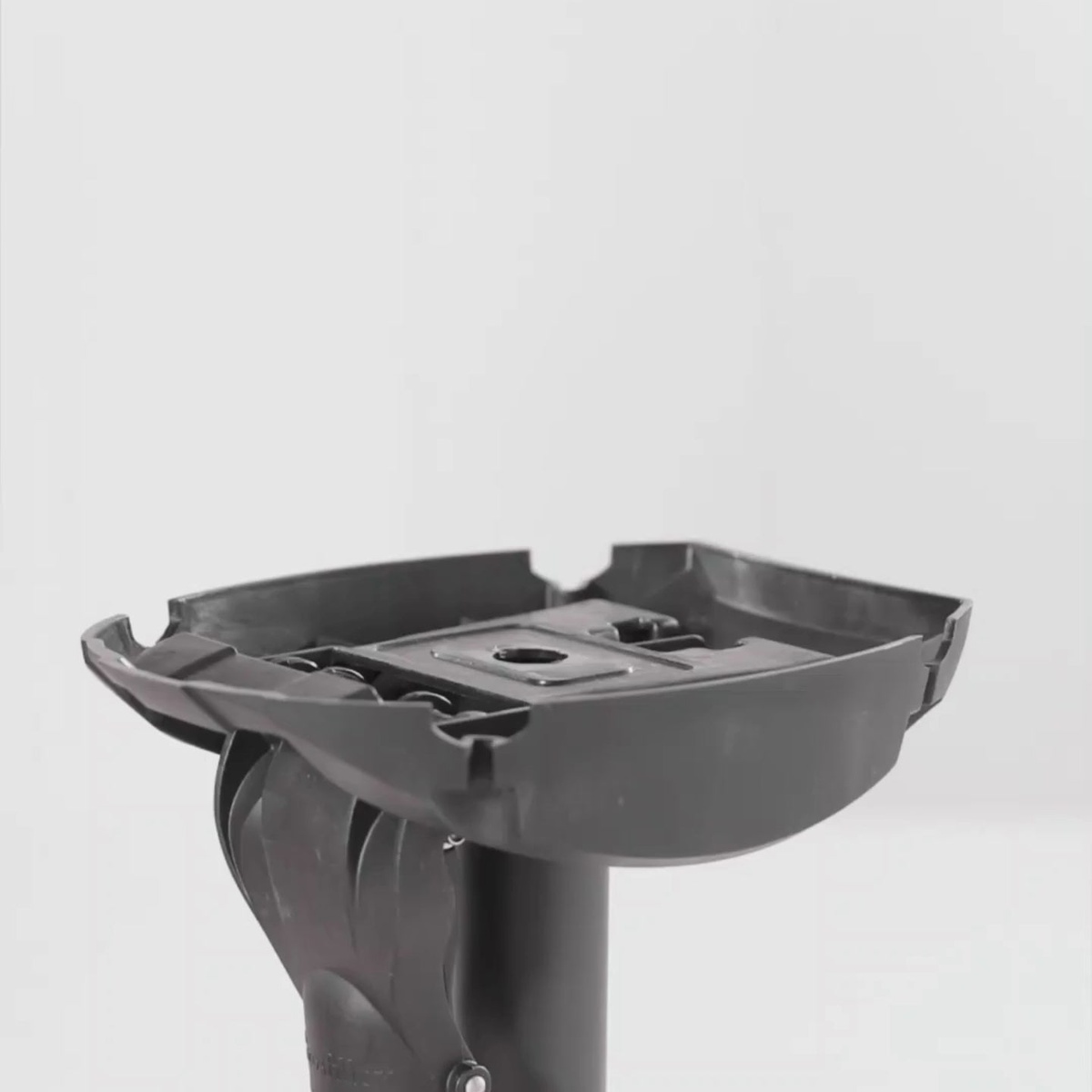 Close-up of Grosfillex X-One tilt-top folding mechanism and top mounting bracket in black