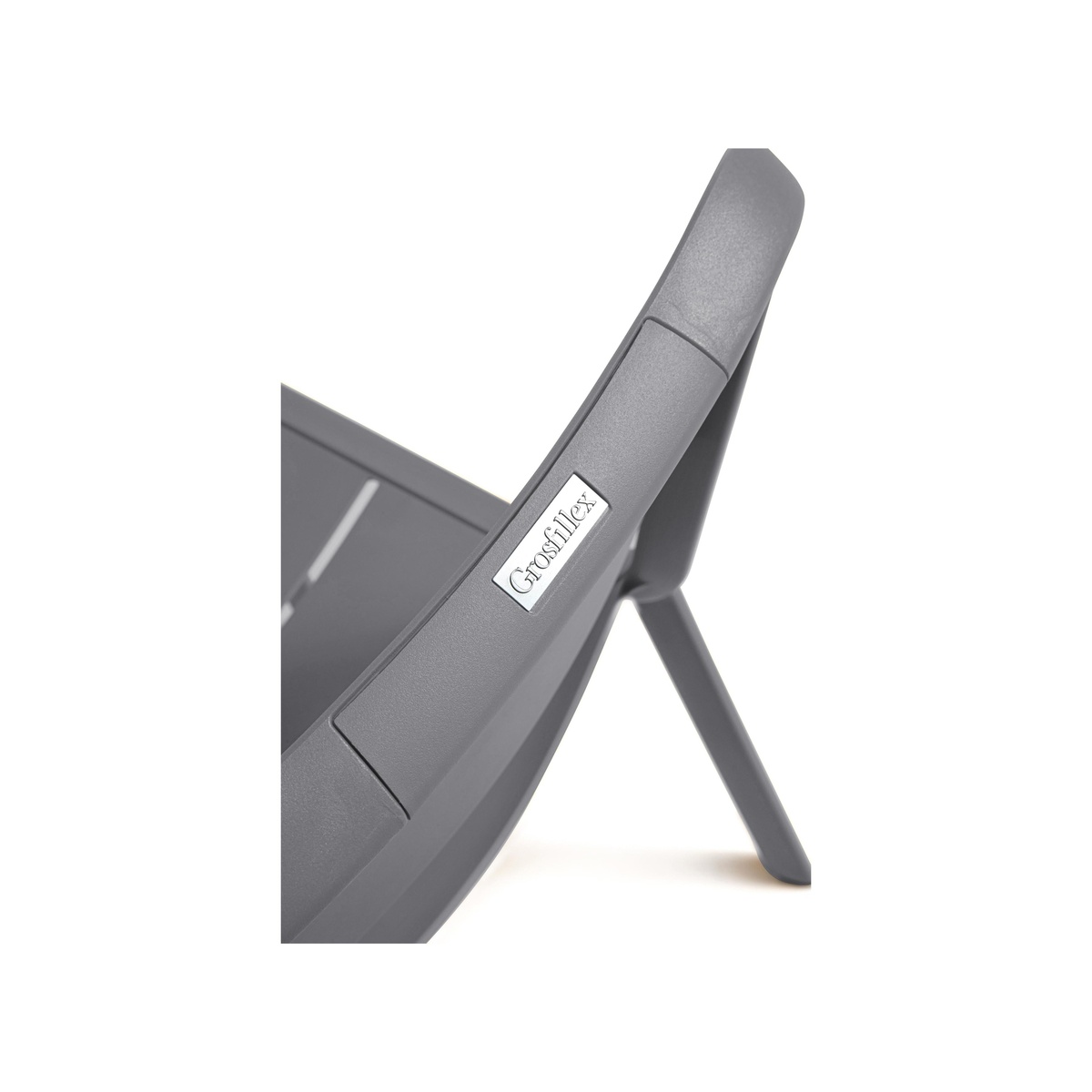 Close-up of Grosfillex branded badge on charcoal Cannes chair frame showing resin texture and slotted seat detail