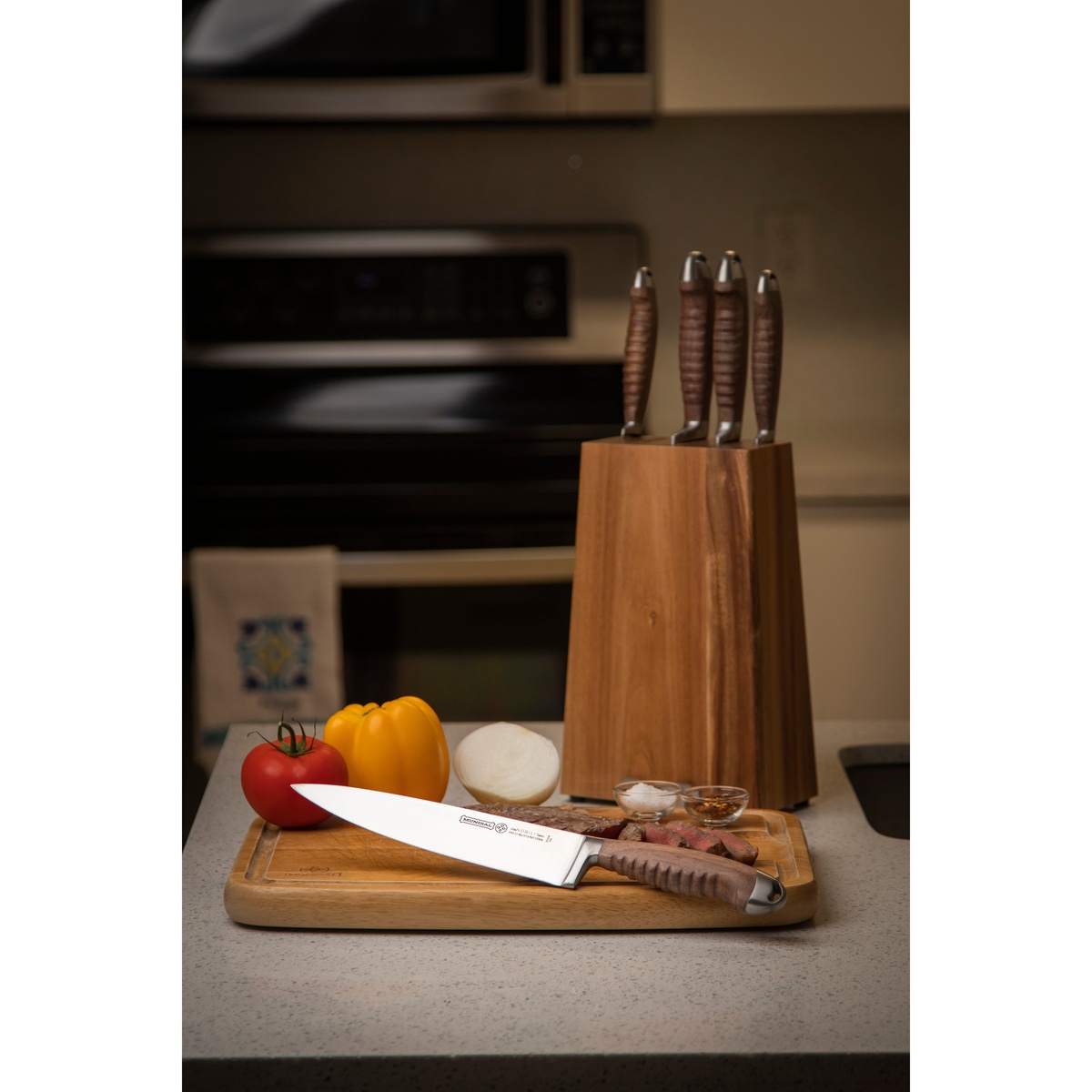 Mundial Chef Knife on a wooden cutting board with fresh vegetables