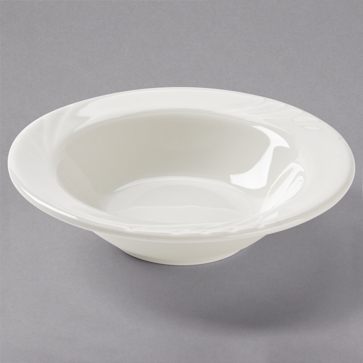 Tuxton YED-063 Monterey eggshell embossed rim china grapefruit bowl on gray background