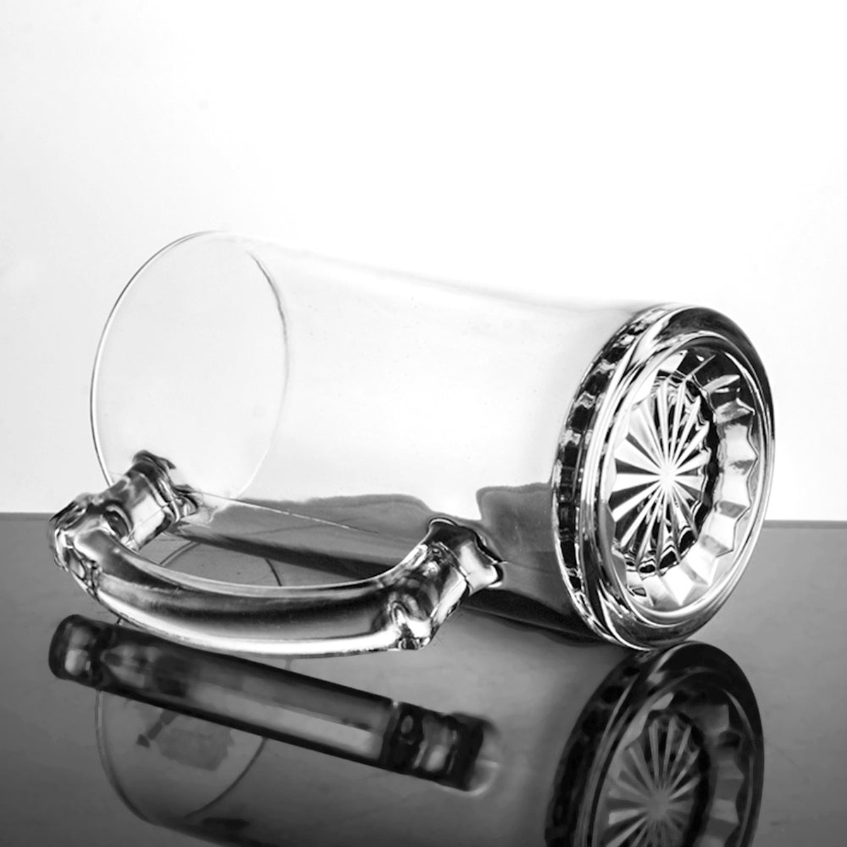 Enhanced Z2726T 25 oz. glass mug shown on its side, displaying the molded starburst base pattern and handle