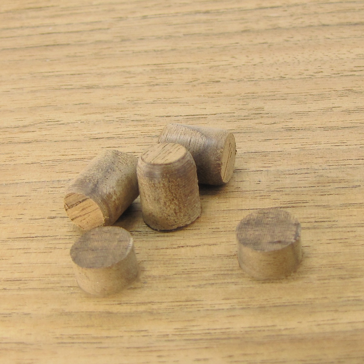 Snappy Tools 43300 3 Piece Tapered Plug Cutter Set wood plugs cut for concealing screws in a woodworking project on a wood tabletop
