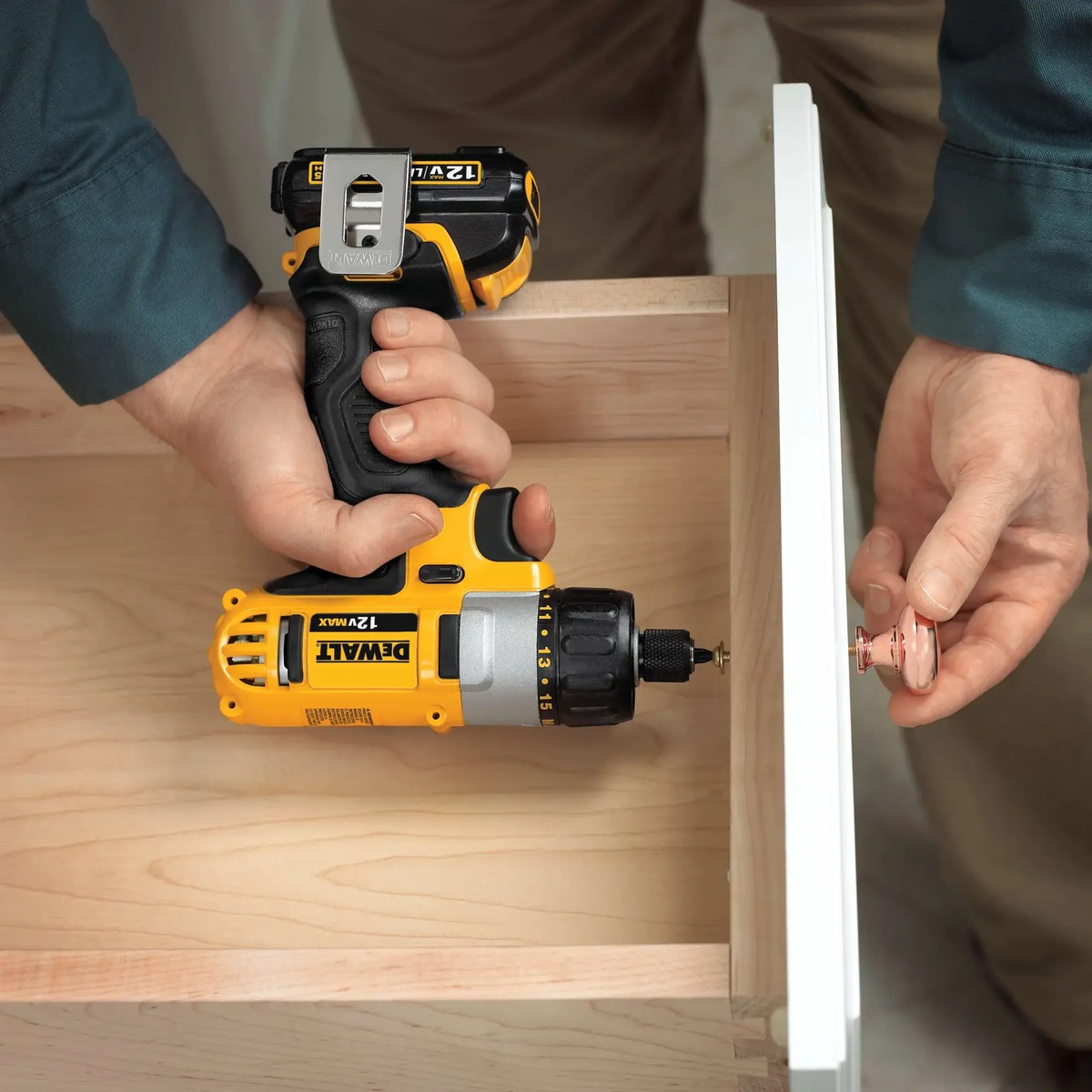 DEWALT DCF610S2 12V MAX 1/4 in screwdriver kit installing cabinet hardware on a wood drawer in interior finish work