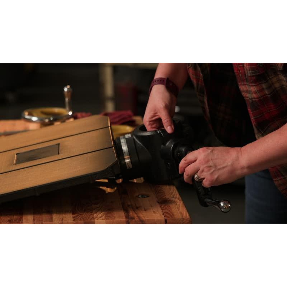 Close-up of Powermatic PM2800B drill press table and adjustment controls being set for repeat hole drilling on a woodworking bench