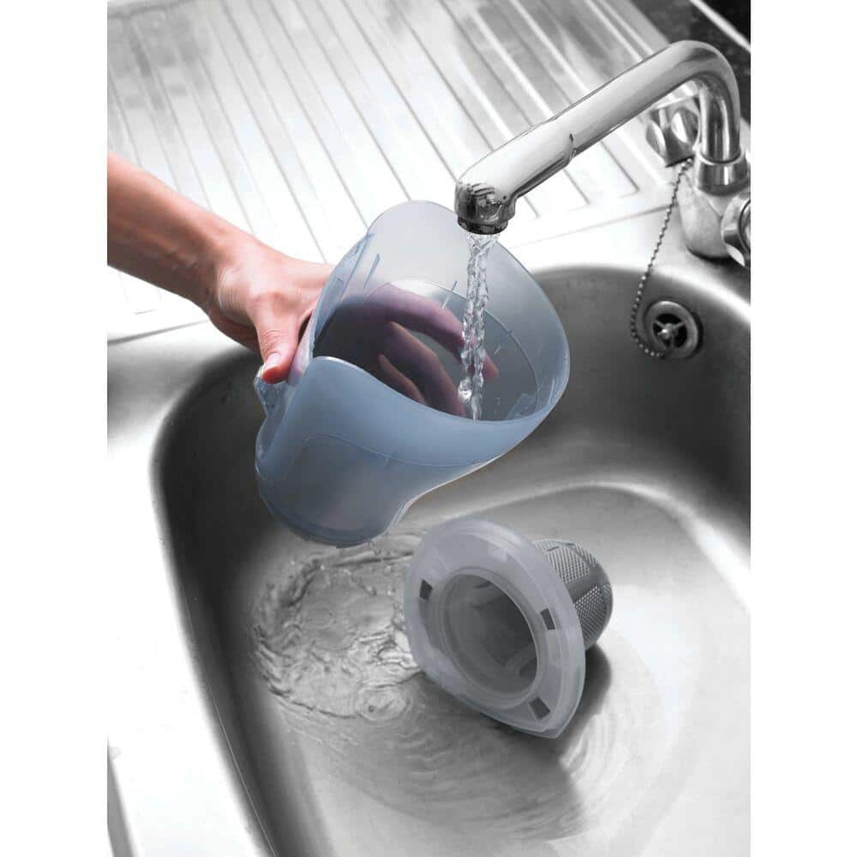 BLACK+DECKER CHV1410L dustbuster handheld vacuum removable dirt bowl and filter being washed in a sink during regular maintenance
