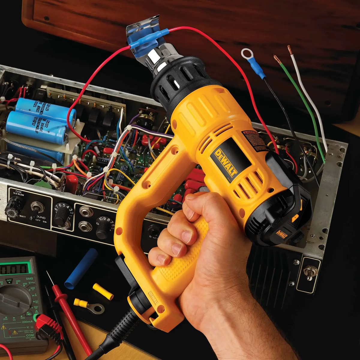 DeWALT D26960K heat gun used for electronics repair work with wires and components on a bench