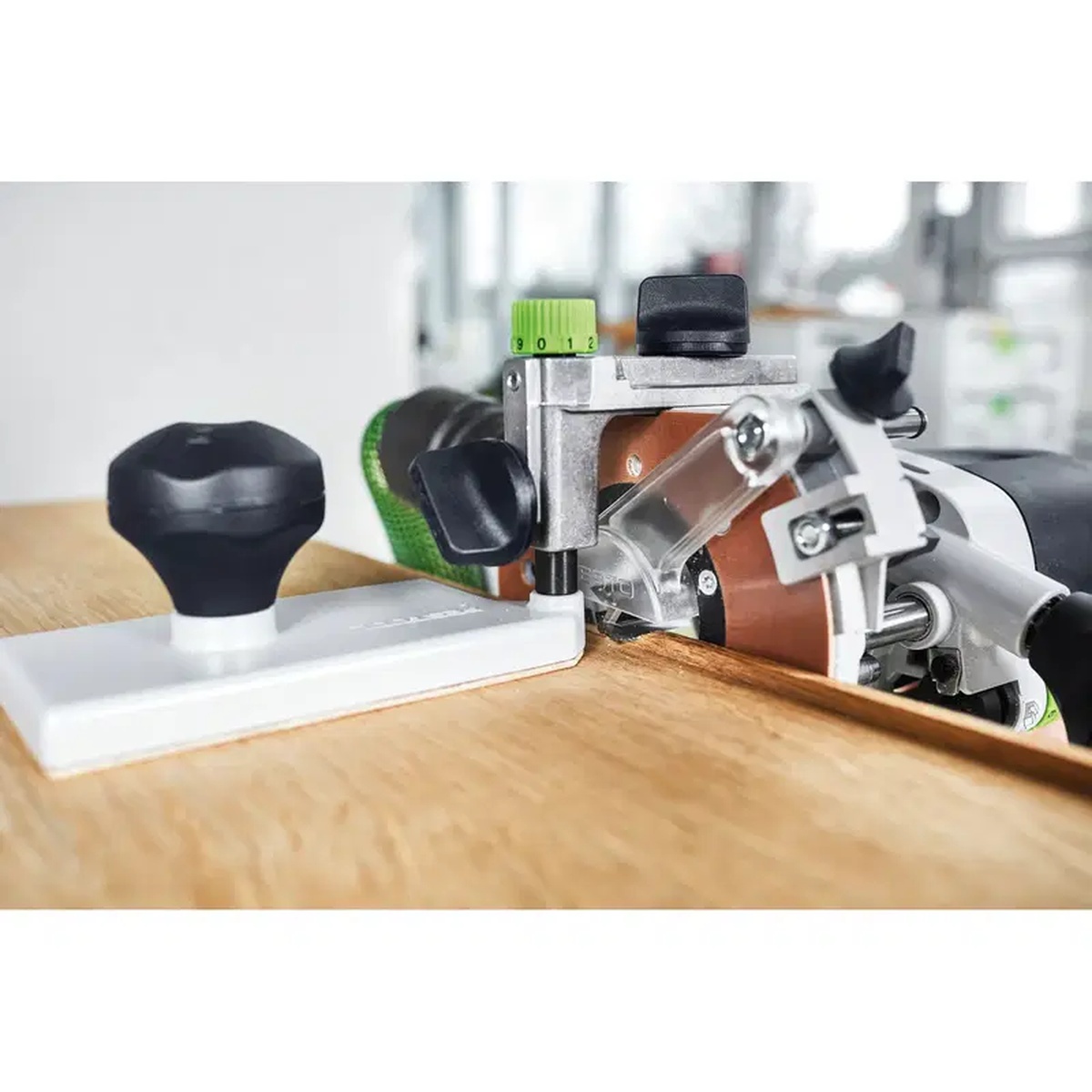 Festool 486058 Edging Plate UP-OF guiding a Festool router during flush trimming on a wood panel edge in a workshop setting