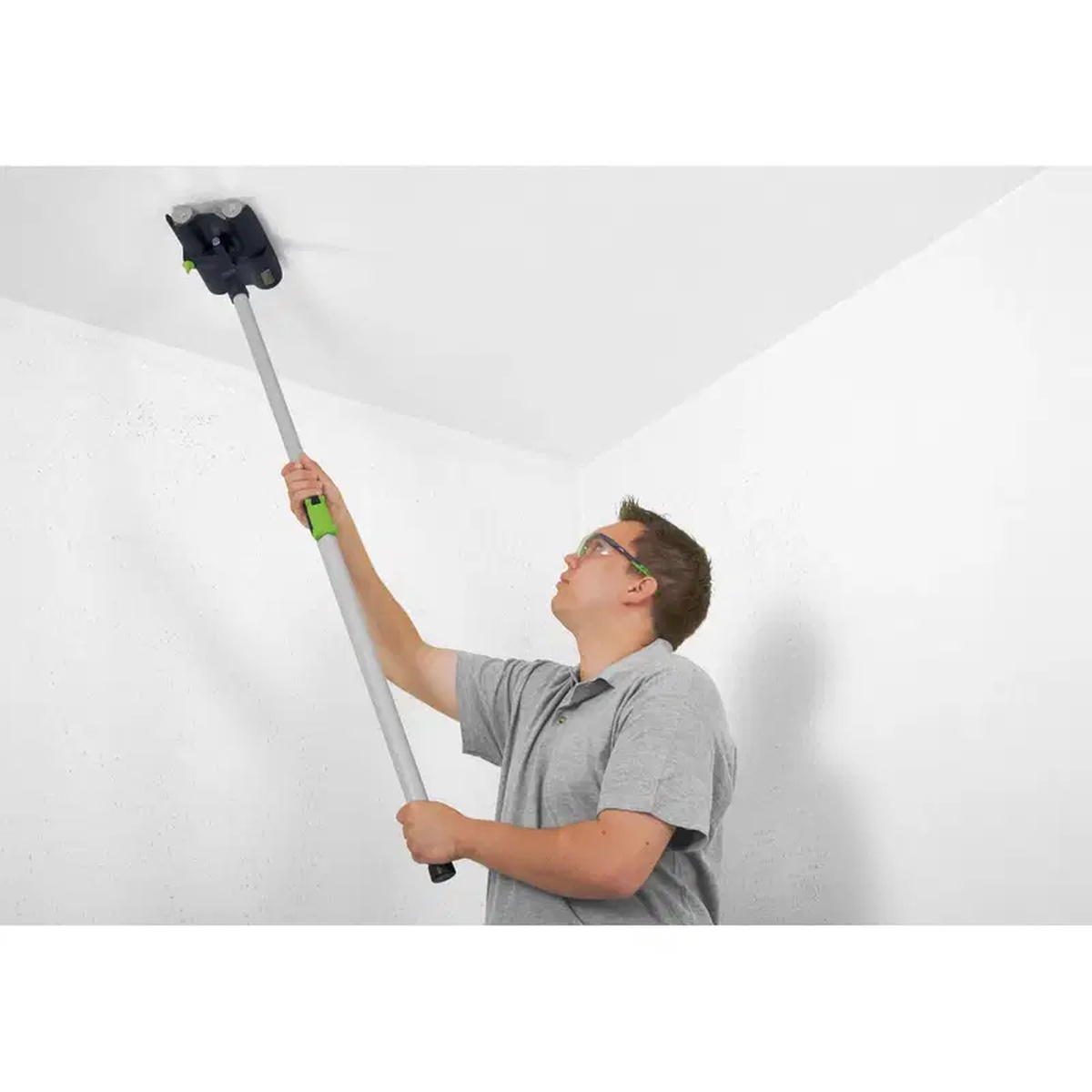 Festool 495747 TP 220 Fakir Wallpaper Perforator used overhead on a ceiling in an interior room
