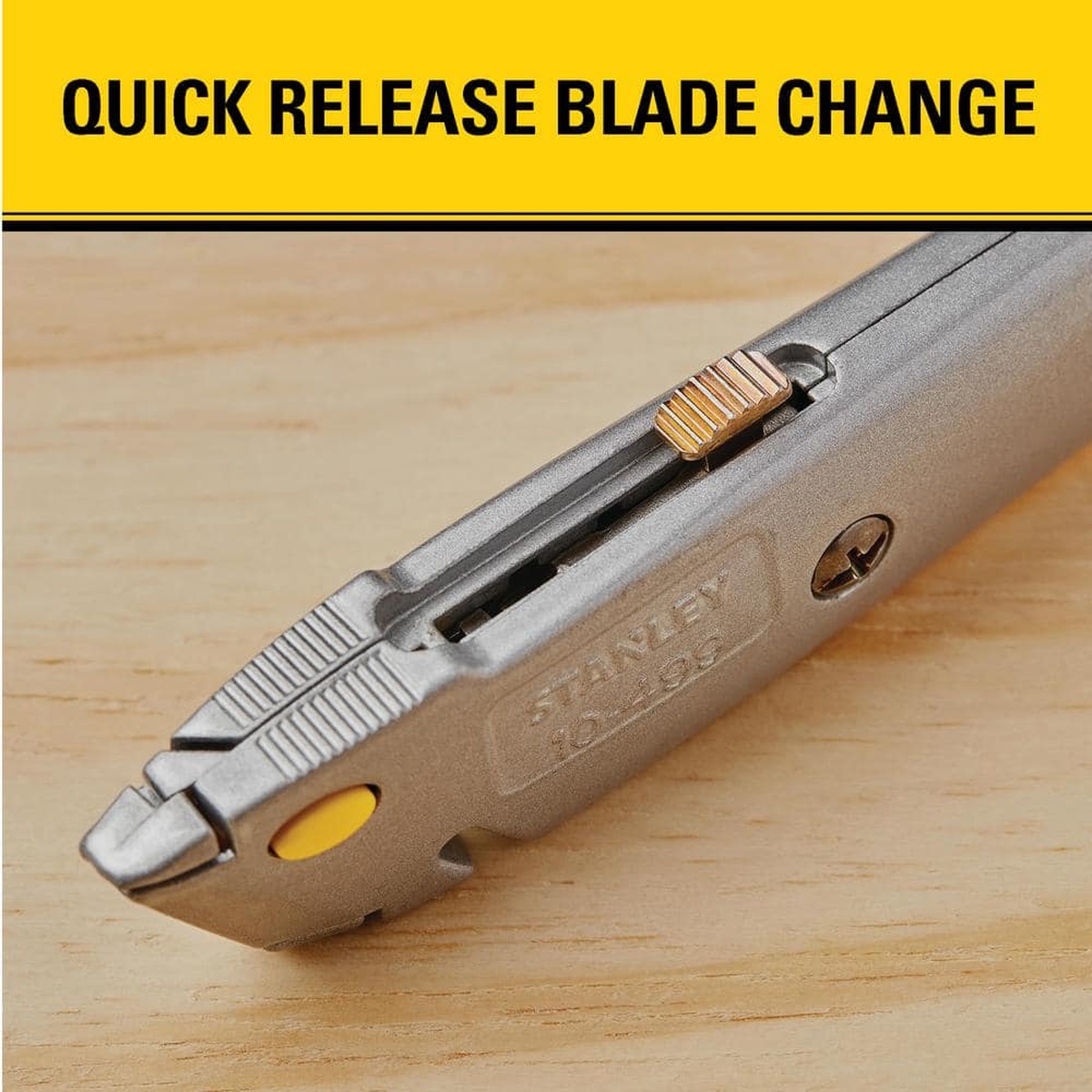 Stanley 10-499 quick-change retractable utility knife detail showing blade change mechanism on a workbench for fast blade replacement during cutting tasks