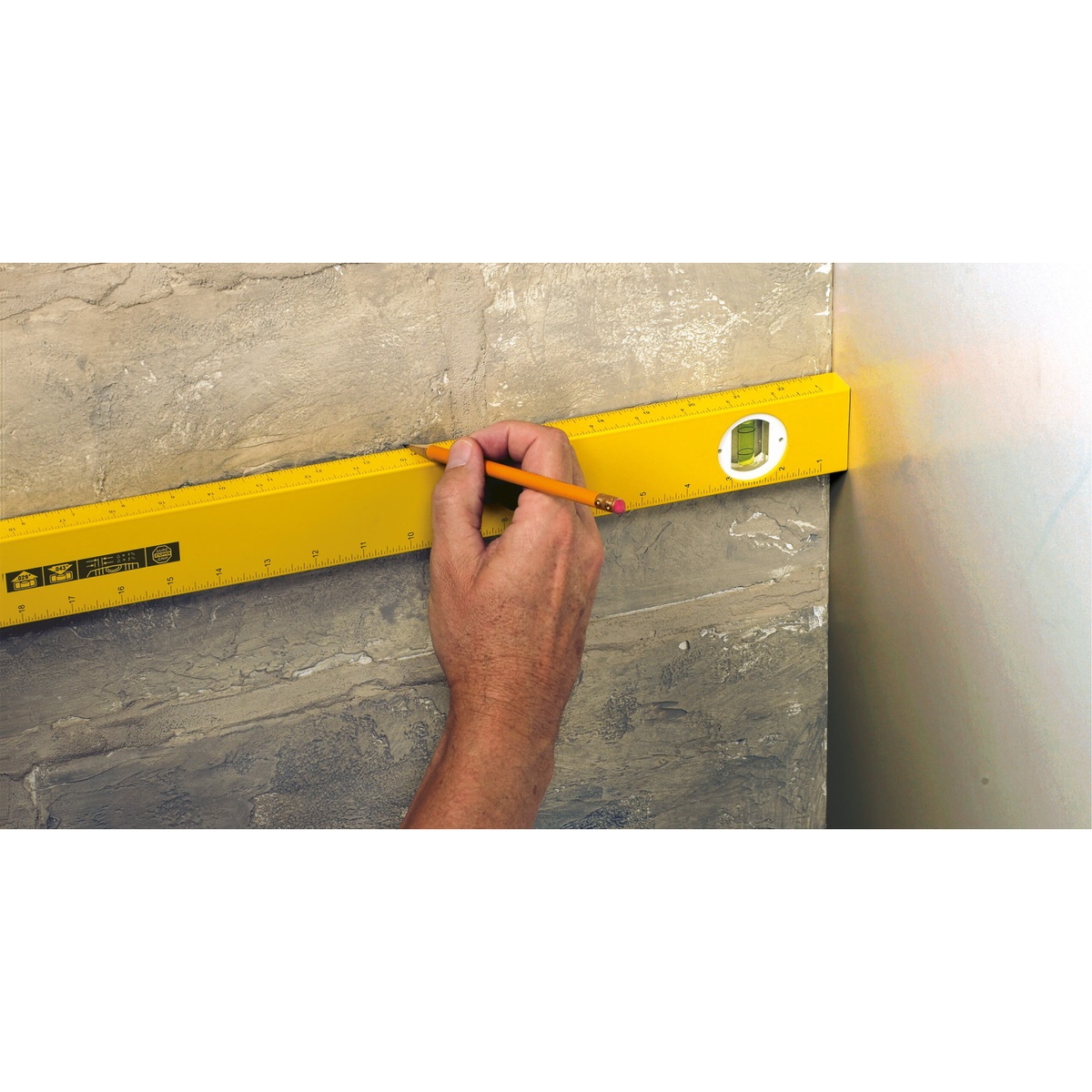 Stabila 29148 48 in. Type 80A-2 Measuring Stick Level marking a layout line on a finished wall during remodeling work