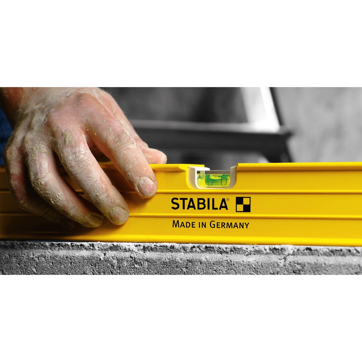 Stabila 29148 48 in. Type 80A-2 Measuring Stick Level resting on a work surface with close-up of the vial and frame during jobsite use
