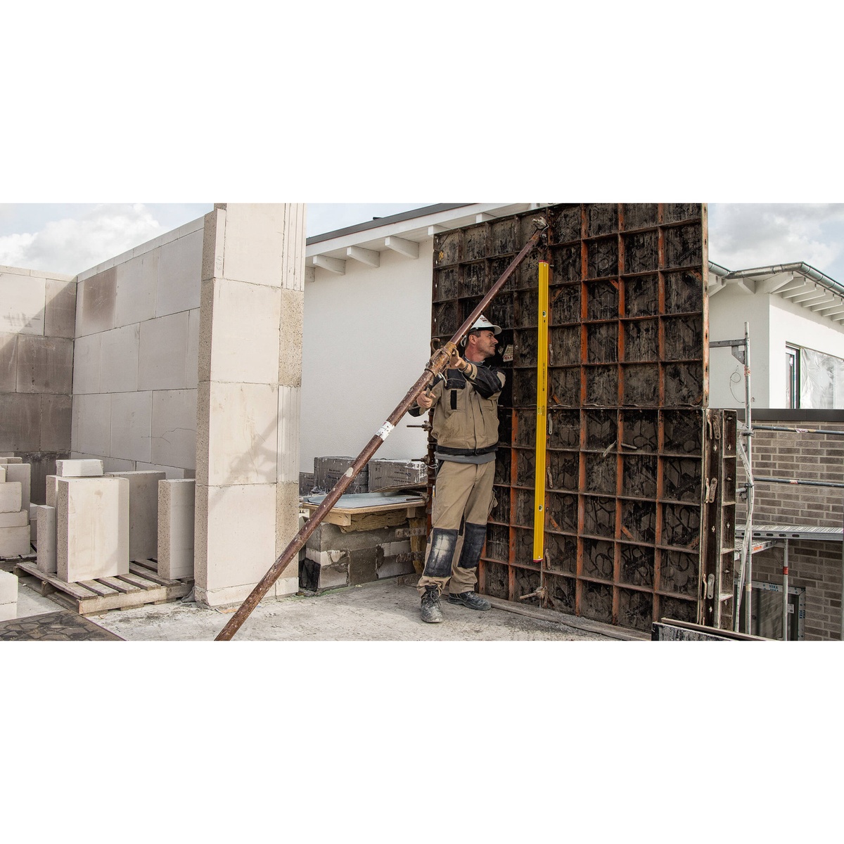 STABILA Type 96M Magnetic Level 48 in standing against large wall formwork on a construction site for vertical leveling work