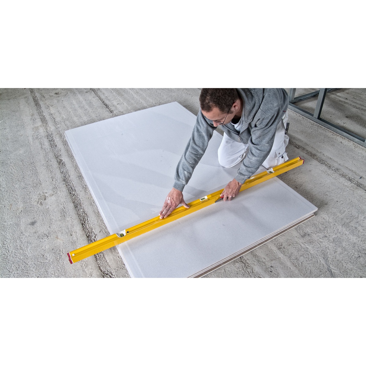 Stabila Type R300 R-Beam level used as a long straightedge for marking and cutting sheet material during interior drywall or panel layout