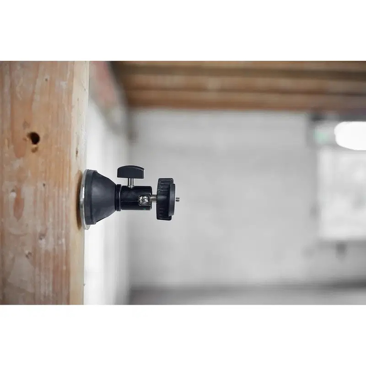 Festool 499814 SysLite Magnetic Mount Head mounted to a jobsite stud for temporary work light positioning during interior construction
