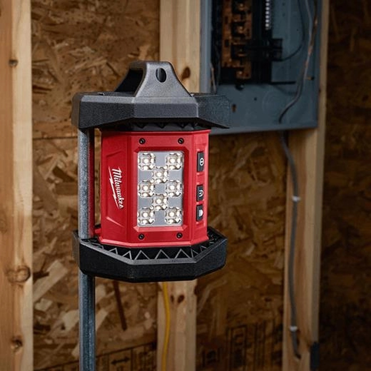 Milwaukee M18 ROVER Flood Light (Tool-Only) mounted in a framed interior work area to light wall cavities and electrical rough-in space on a jobsite