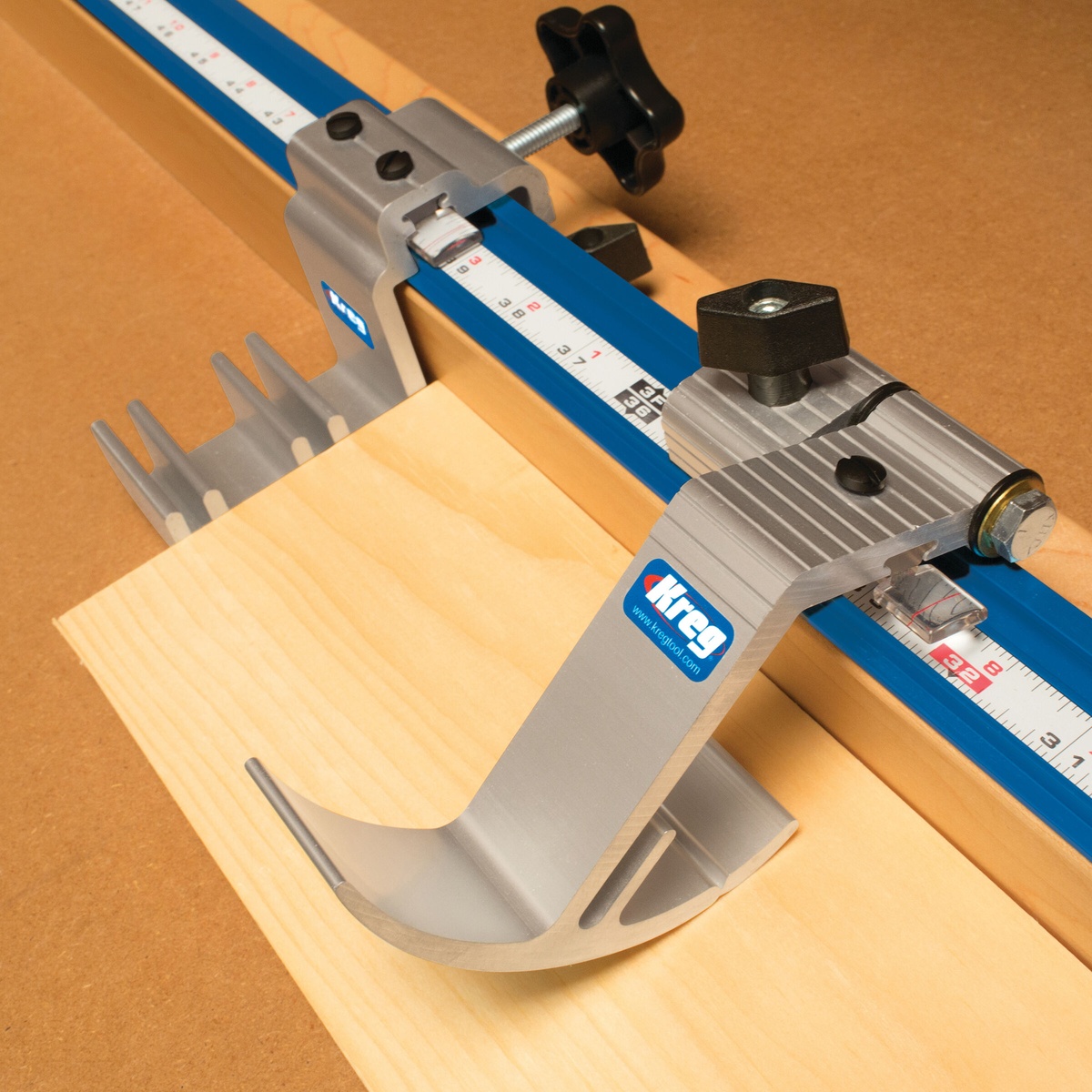 Kreg KMS8000 Precision Trak & Stop Kit showing production stop and swing stop on a wood cutting station in a workshop