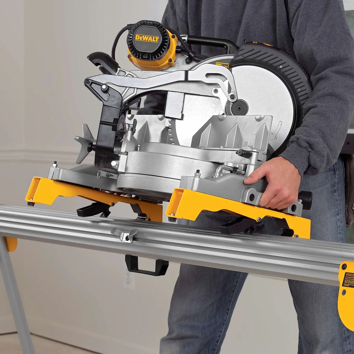 DeWALT DW7231 Tool Mounting Brackets for Miter Saw Stand supporting a miter saw on a DeWALT workstation during trim cutting setup in an indoor jobsite environment