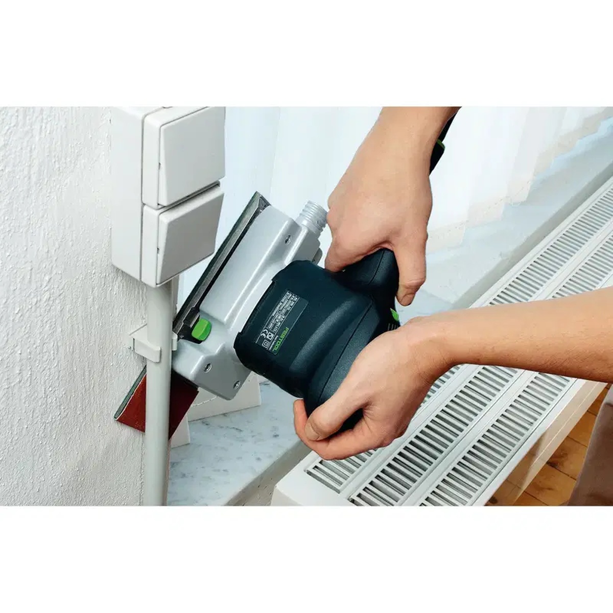 Festool 491861 Flat Sanding Pad Long installed on an LS 130 sander sanding a tight area around wall trim and facings during interior finish work