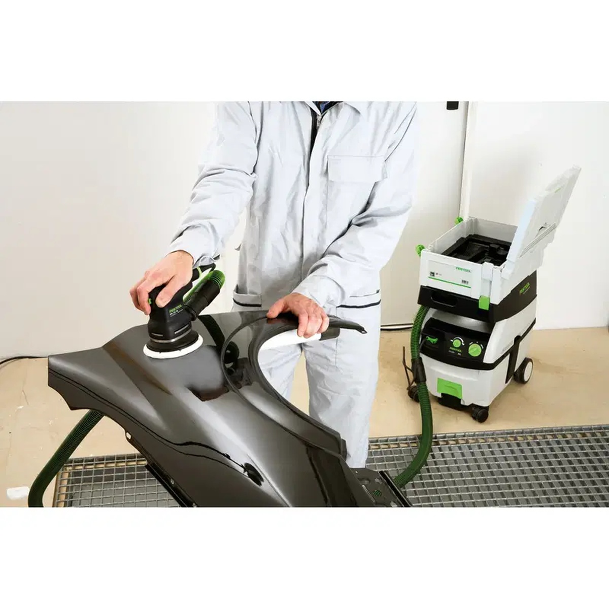 Festool 492282 ETS 125 EQ Jetstream Sanding Pad, Supersoft, 125mm (5 inch) used on a curved automotive panel with a connected dust extractor during finish sanding