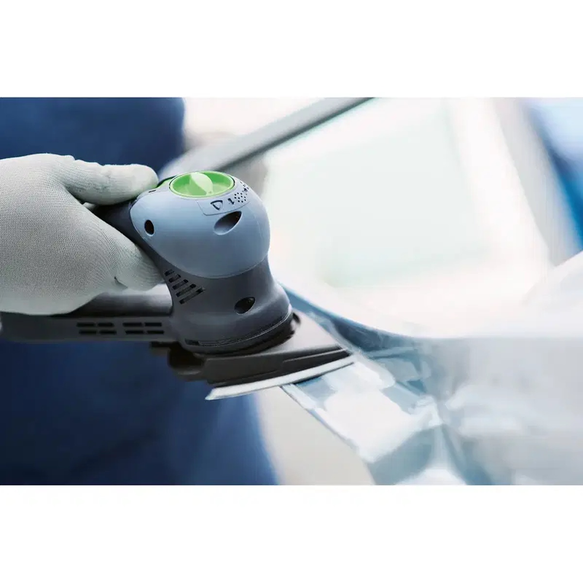 Festool 496802 Triangular Sanding Pad installed on an RO 90 DX sander for detail sanding along a contoured painted automotive panel in a workshop