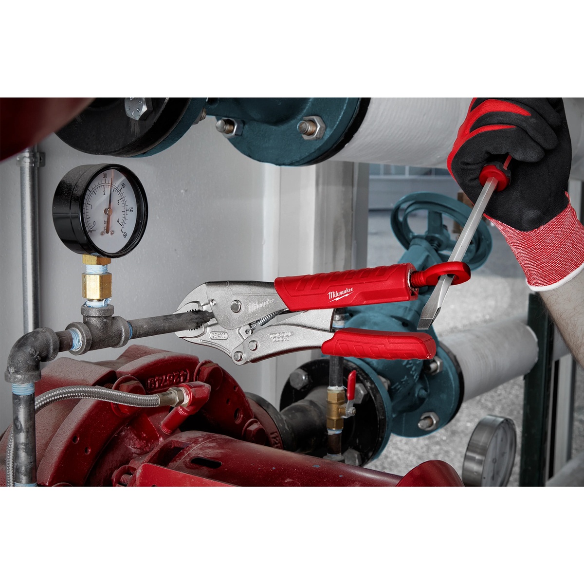 Milwaukee 48-22-3402 Torque Lock Curved Jaw Locking Pliers Set gripping steel pipe during plumbing service work in a mechanical room