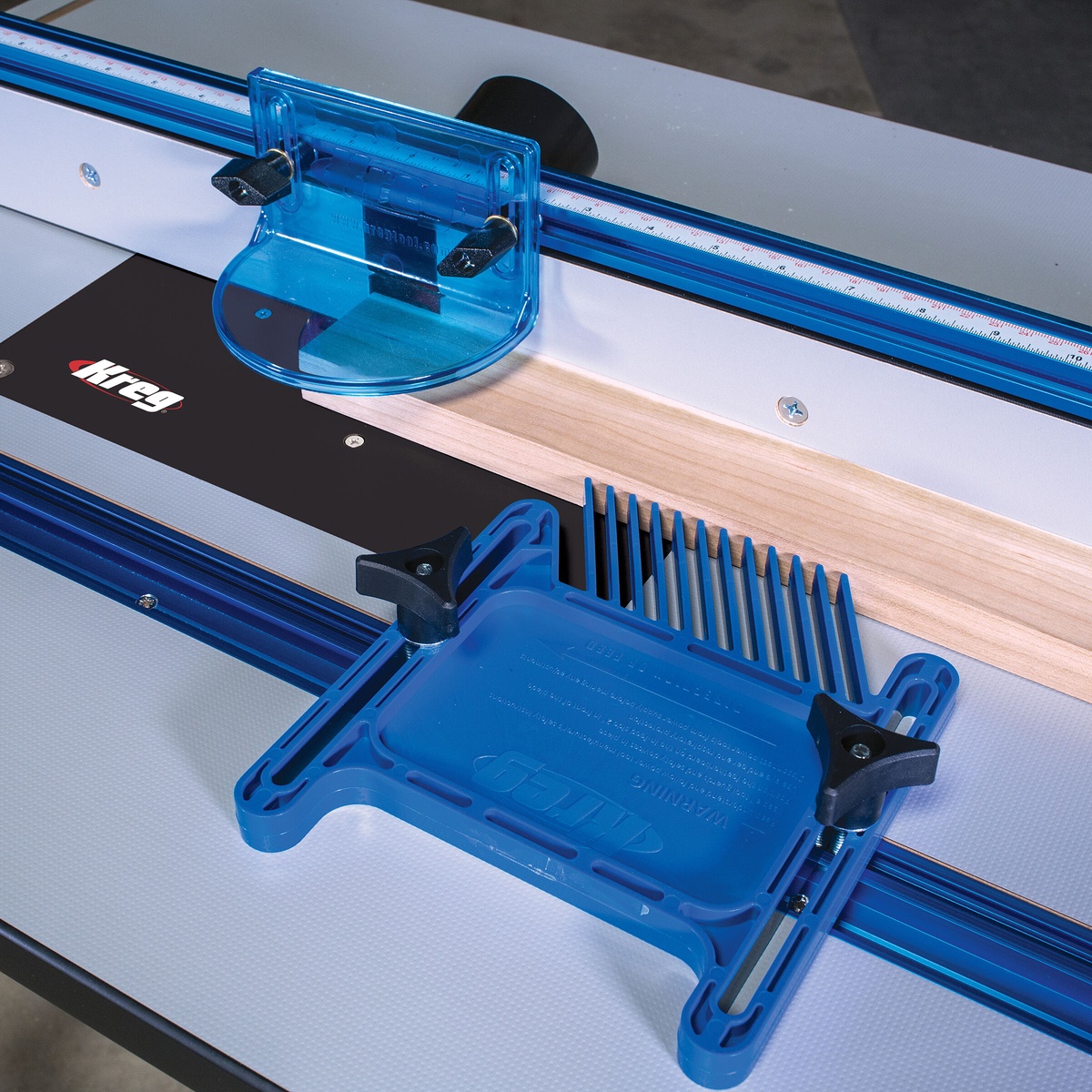 Kreg PRS3010 True-FLEX Featherboard - Single secured in a router table slot next to a wood board for fence-guided routing work