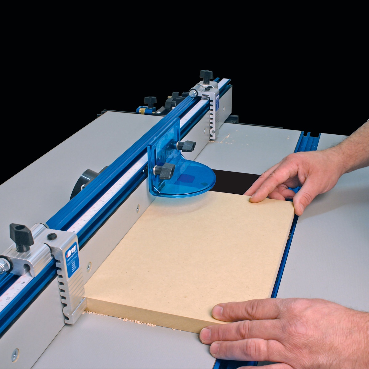 Kreg PRS7850 Precision Router Table Stop in use on a Kreg router table fence guiding sheet stock during repeat woodworking cuts