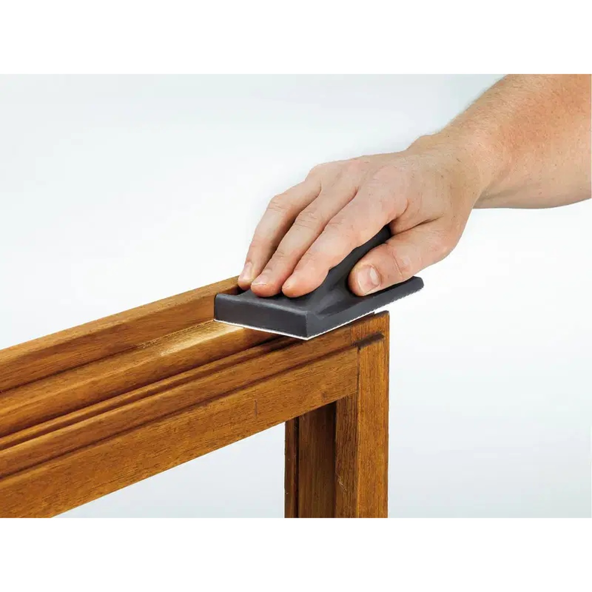 Festool 495967 HSK-80x133 Rectangular Sanding Block (Hard) smoothing a wood cabinet frame edge during detail sanding in a finish carpentry setting