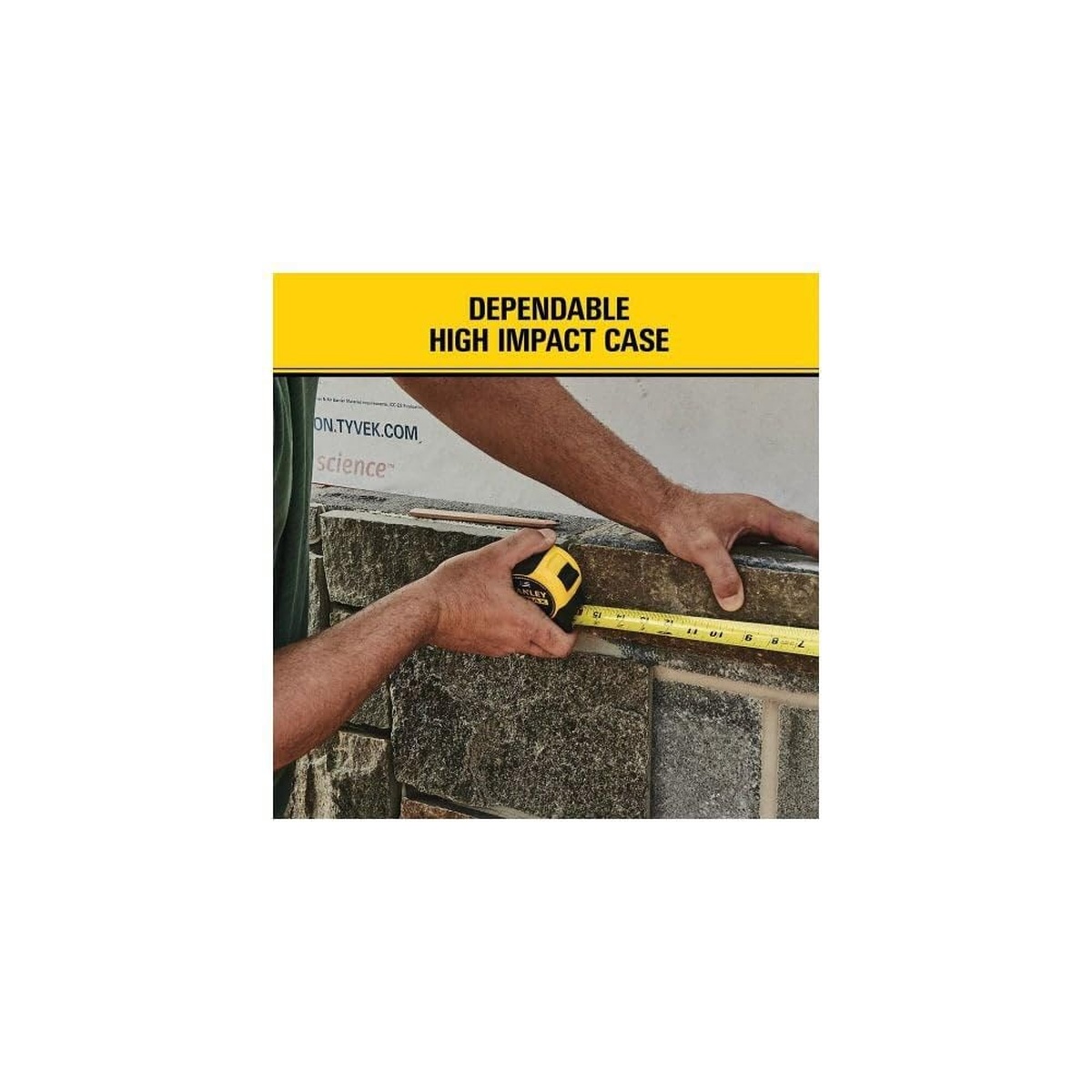 Stanley tape measure used against masonry block on a construction site showing durable case for rough measuring work