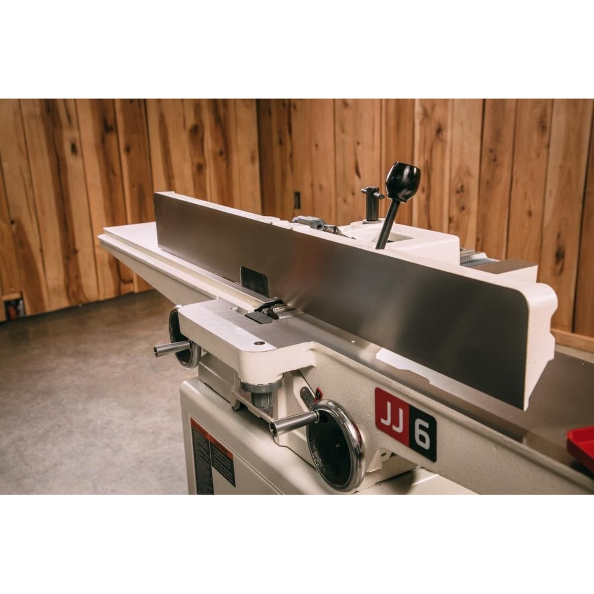 Jet 708457DXK JJ-6CSDX, 6 inch Deluxe Jointer with QS Knives showing the long fence and cast iron tables in a woodworking shop setup for edge jointing lumber