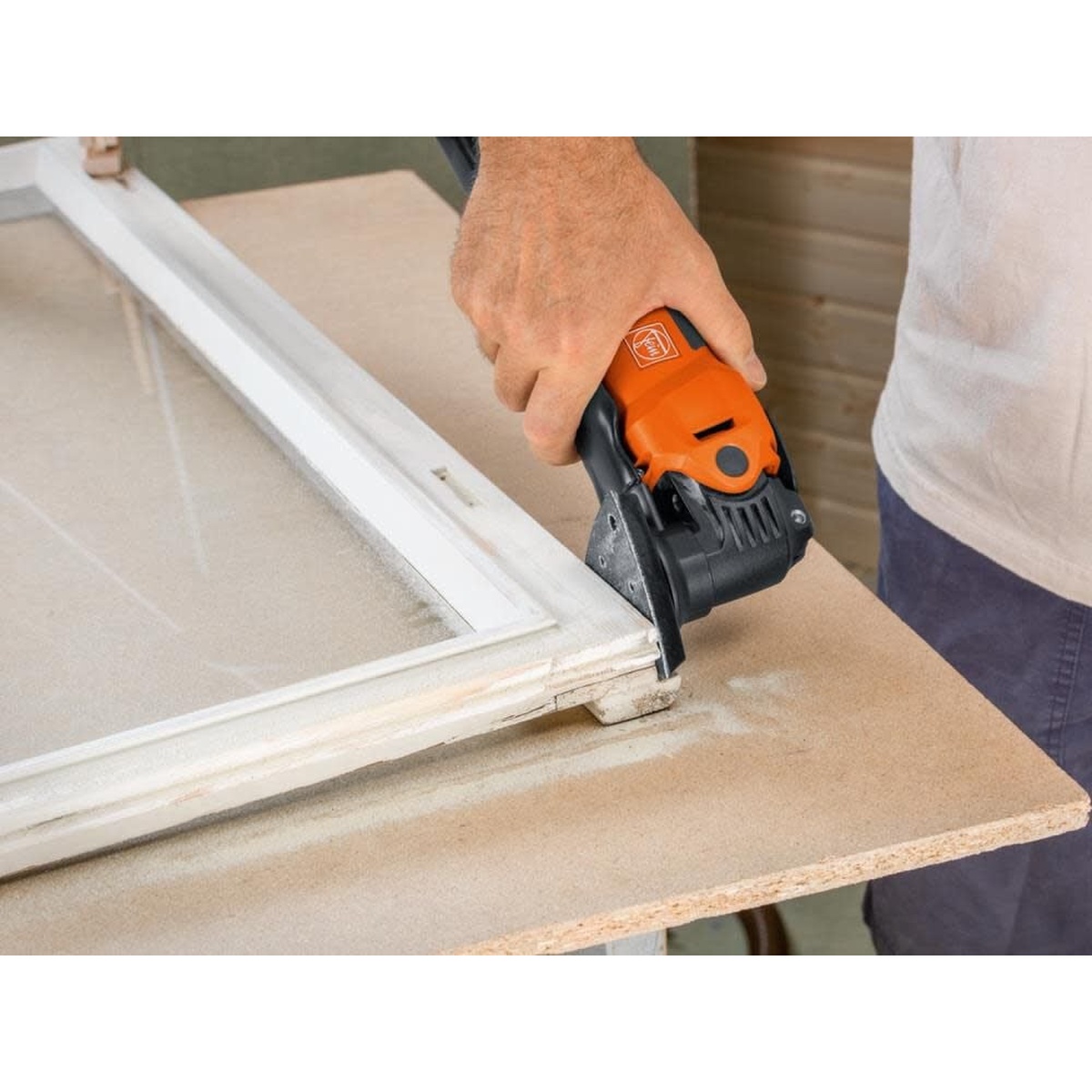 Fein MultiMaster MM 500 Start Q Oscillating Multi-Tool sanding the edge of a wood frame panel during finish and renovation work