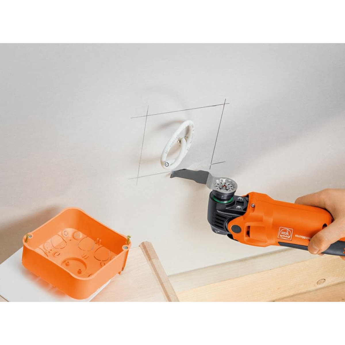 Fein MultiMaster MM 500 Start Q Oscillating Multi-Tool making a drywall cutout for an electrical box during interior remodeling
