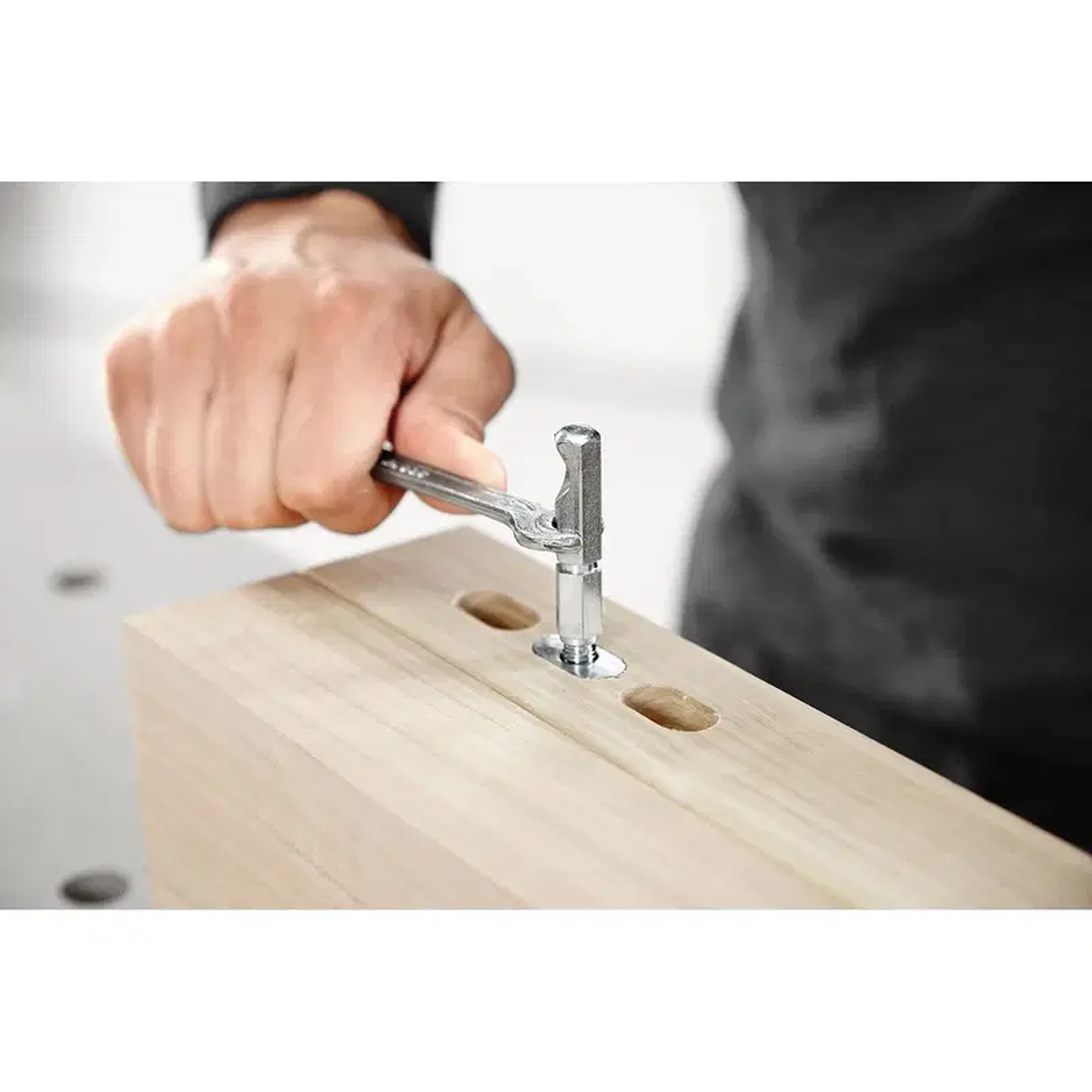 Festool 203420 Domino XL Corner Joint Connector Set, 32-Pack being tightened with a hex wrench during wood assembly work