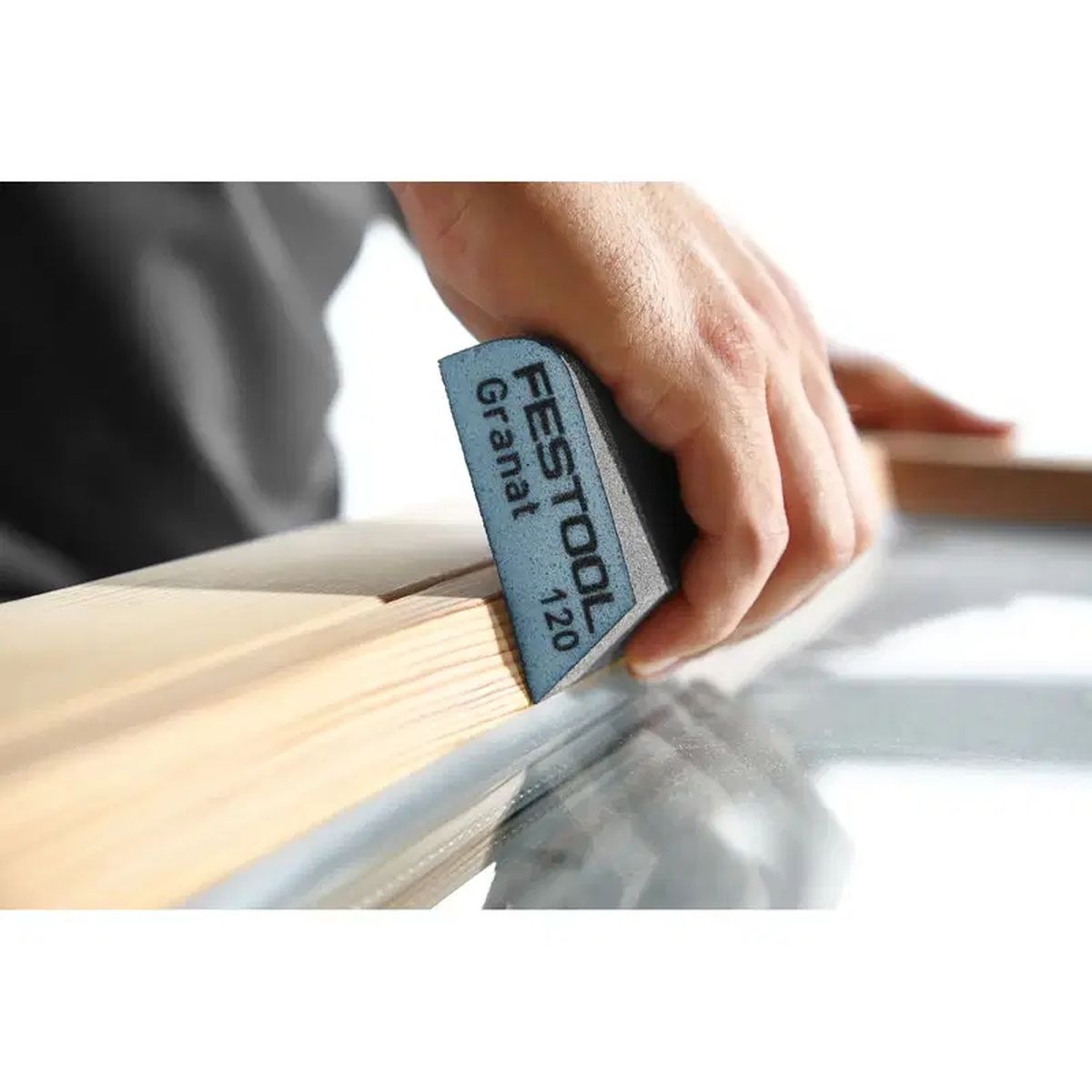 Festool 201084 Granat Concave Abrasive Sanding Block, 120 Grit, 6-Pack sanding a wood edge by hand during finish prep on a bench