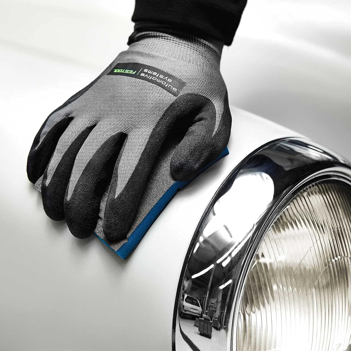 Festool 201112 Granat Abrasive Sponge, 60 Grit, 6-Pack hand sanding a curved automotive panel during surface prep work