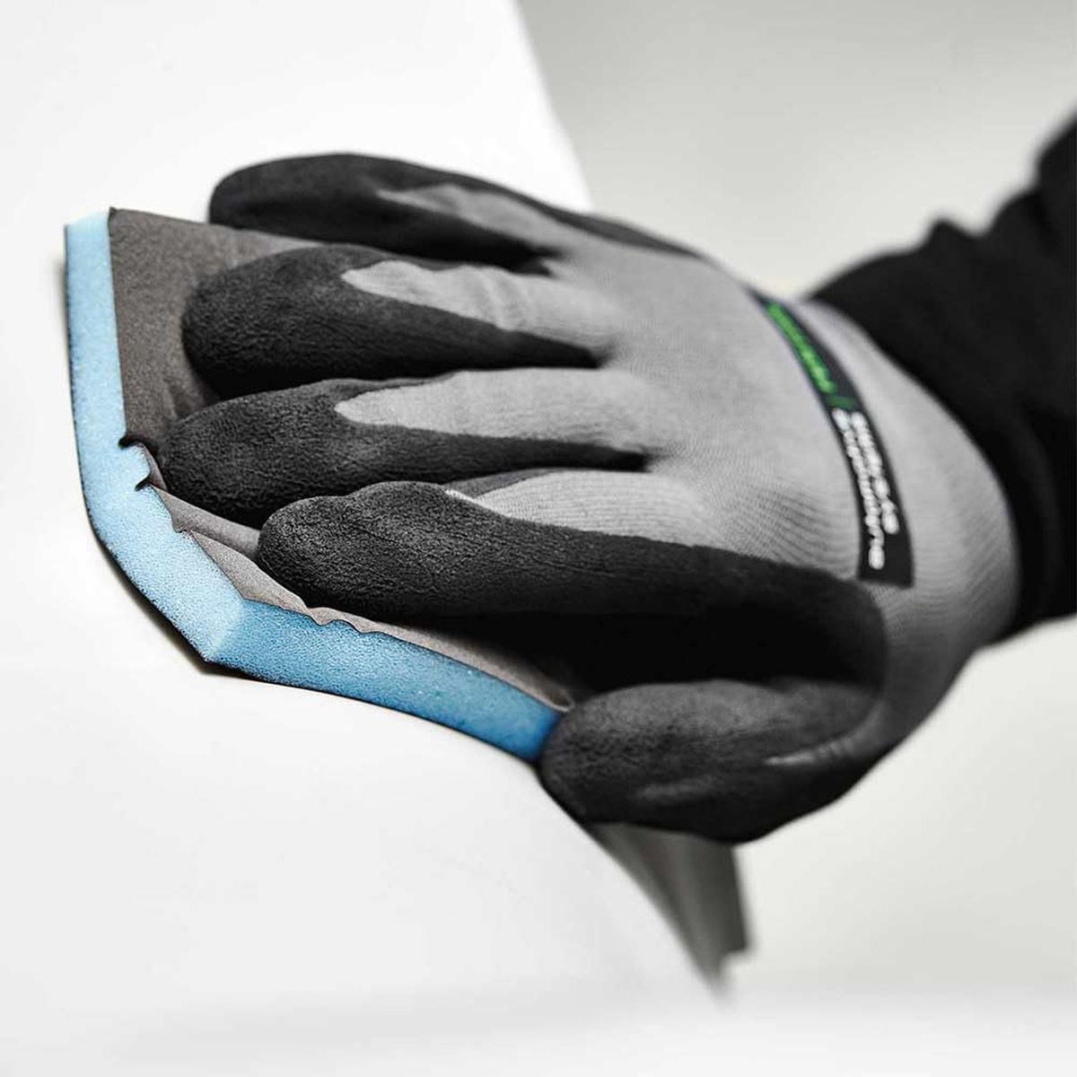 Festool Granat abrasive sponge flexing over a contoured panel while sanding repair surfaces and coated material