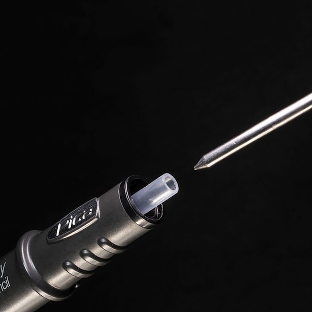Pica Dry 4030 Black Lead Refill being loaded into a Pica Dry marker for fast replacement on the bench