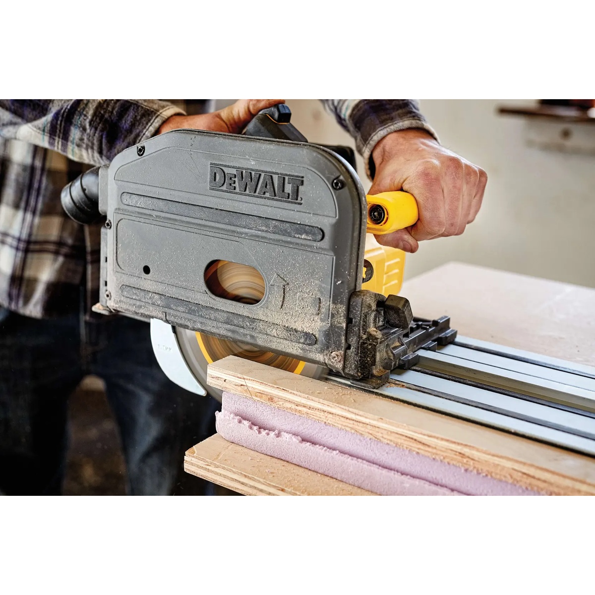 DeWALT DCS520ST1 60V MAX Brushless Cordless 6-1/2 in. Track Saw Kit making a guided plunge cut through plywood during cabinet and panel work