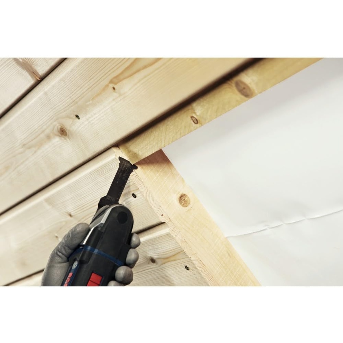 Bosch OSM114F 1-1/4 In. StarlockMax Bi-Metal Plunge Cut Blade making an in-place plunge cut in framing lumber during interior remodeling work