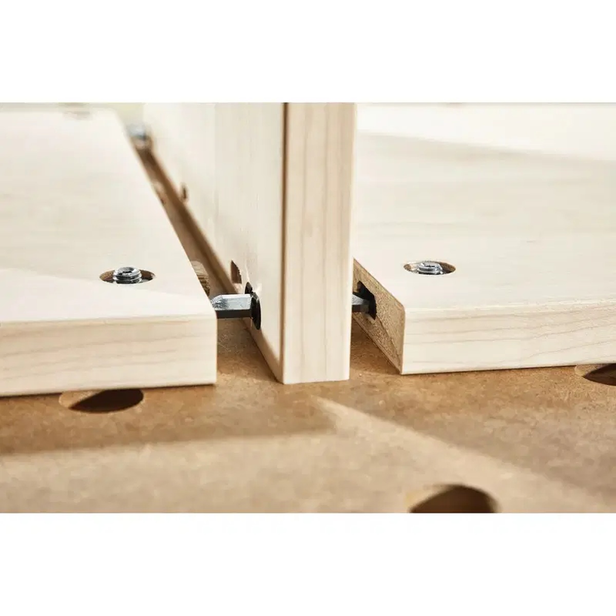Festool center panel connector aligning wood cabinet parts during dry fit on a workbench for detachable panel construction