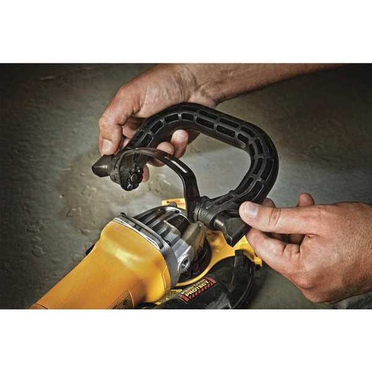 DeWALT DWE46005 Adjustable Bail Grinder Handle installed on a grinder for added control during metal grinding work in a shop setting