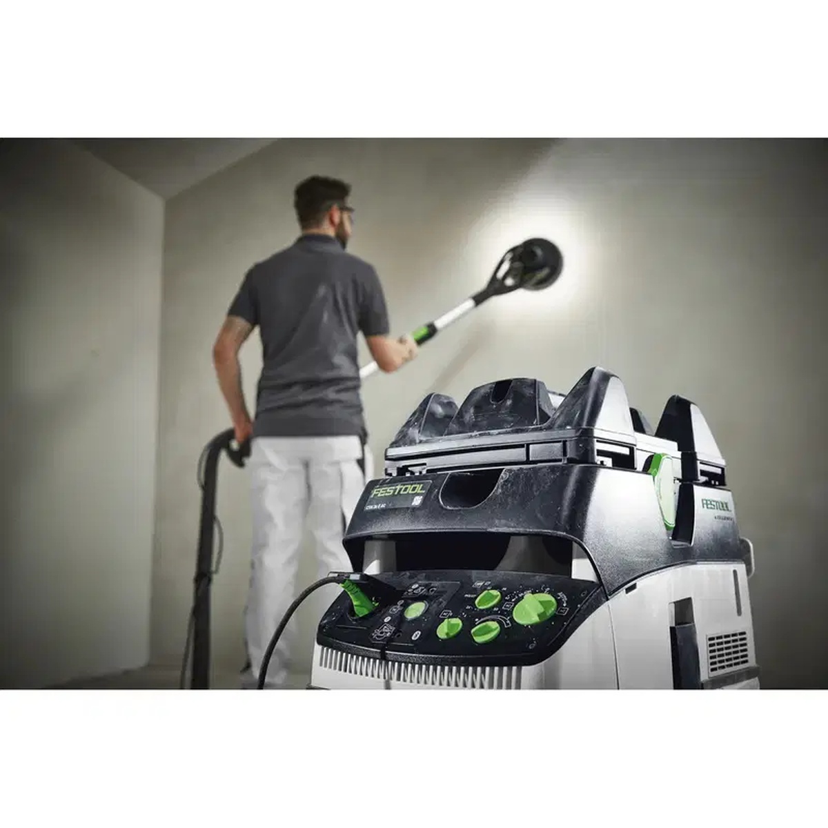 Festool CT dust extractor with mounted tool holder used as a mobile sanding station during wall and ceiling finishing in a work area