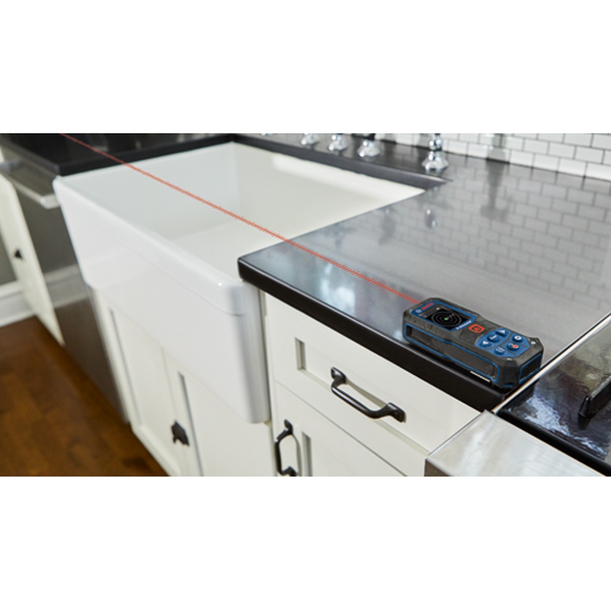 Bosch GLM165-22 BLAZE 165 Ft. Laser Measure used for countertop and cabinet spacing measurements in a kitchen remodeling setting