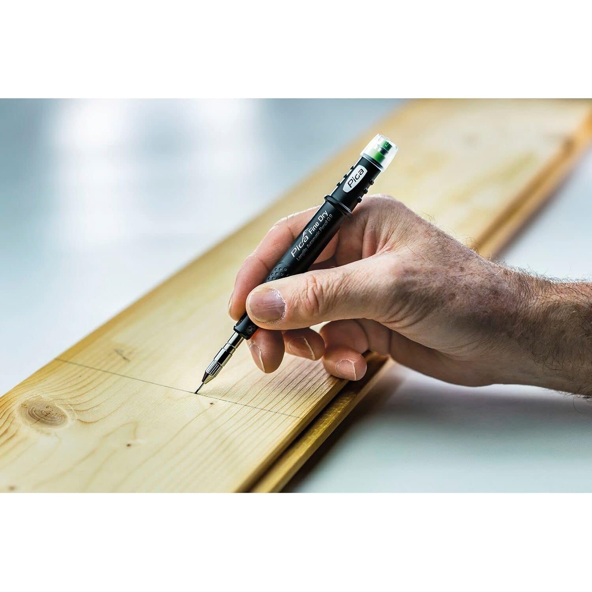Pica Fine Dry 7070 Longlife Automatic Pencil 0.9 making a fine layout mark on a wood board during carpentry marking work