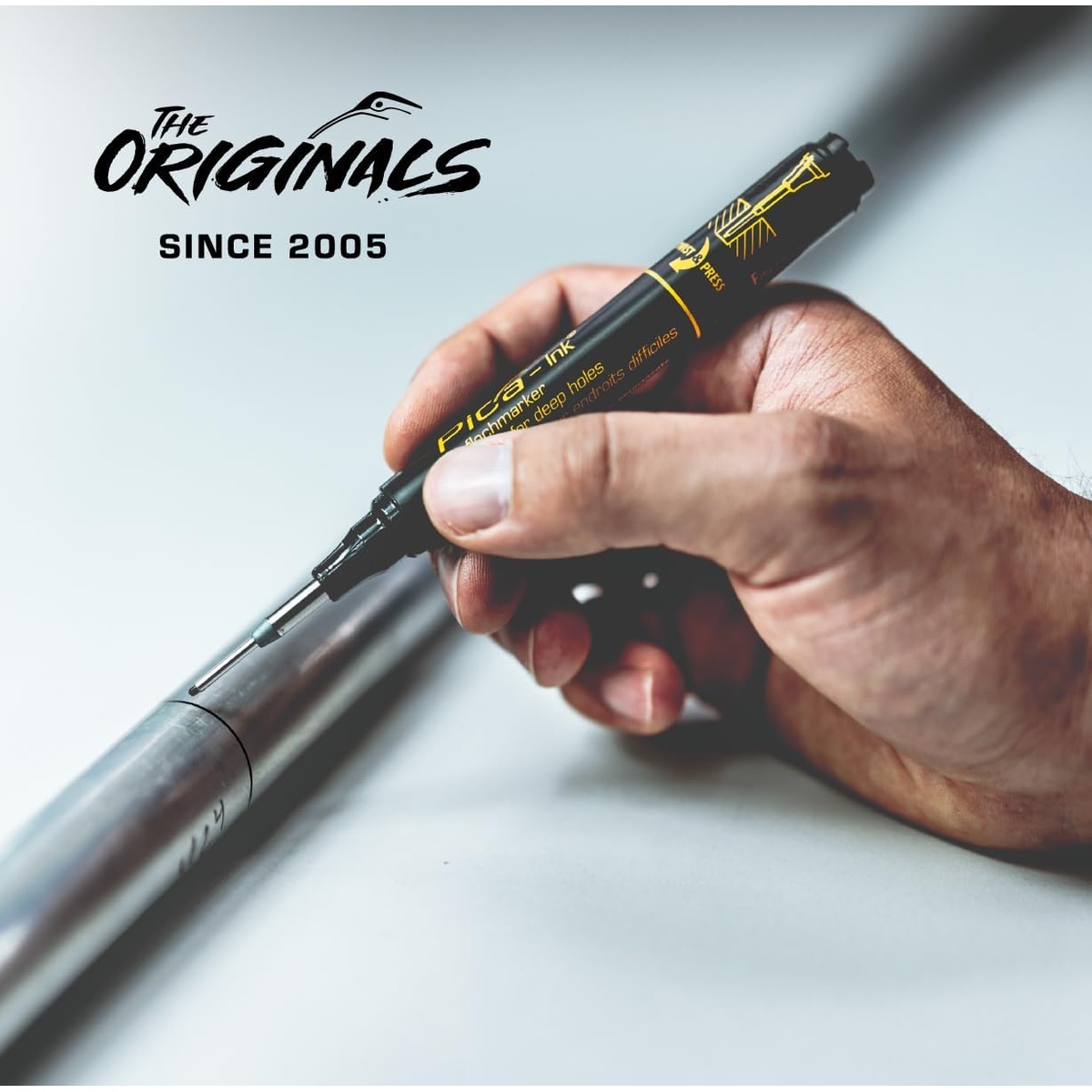 Pica Dry 150/46 Marker for Deep Holes, Black marking inside a metal tube during installation work in a shop or jobsite setting