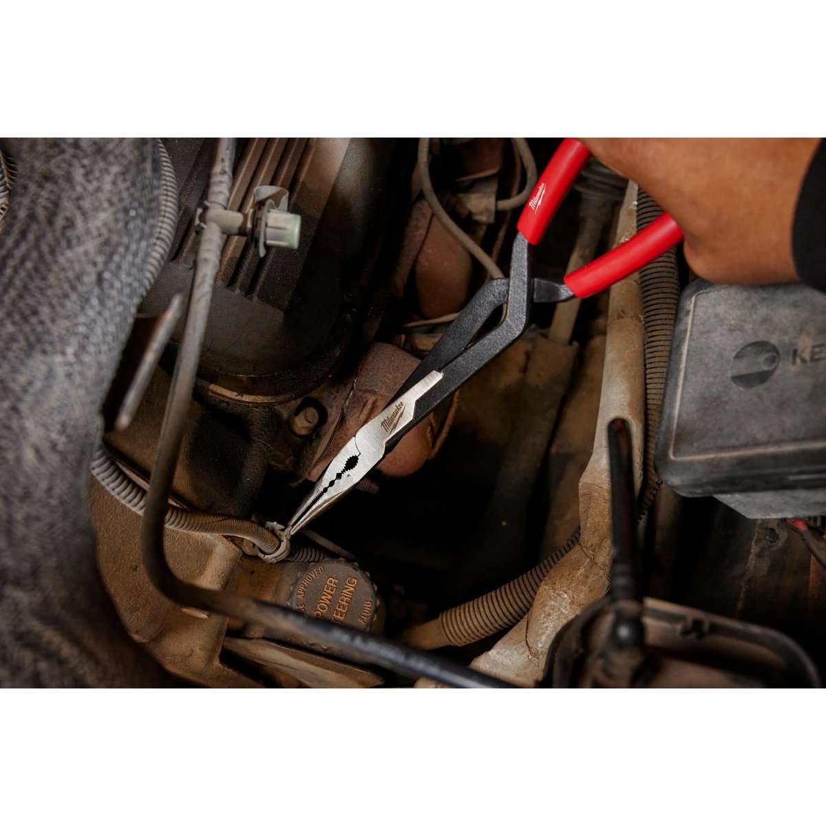 Milwaukee 48-22-6540 13 inch long reach straight nose pliers gripping wire in a cramped engine compartment during service work