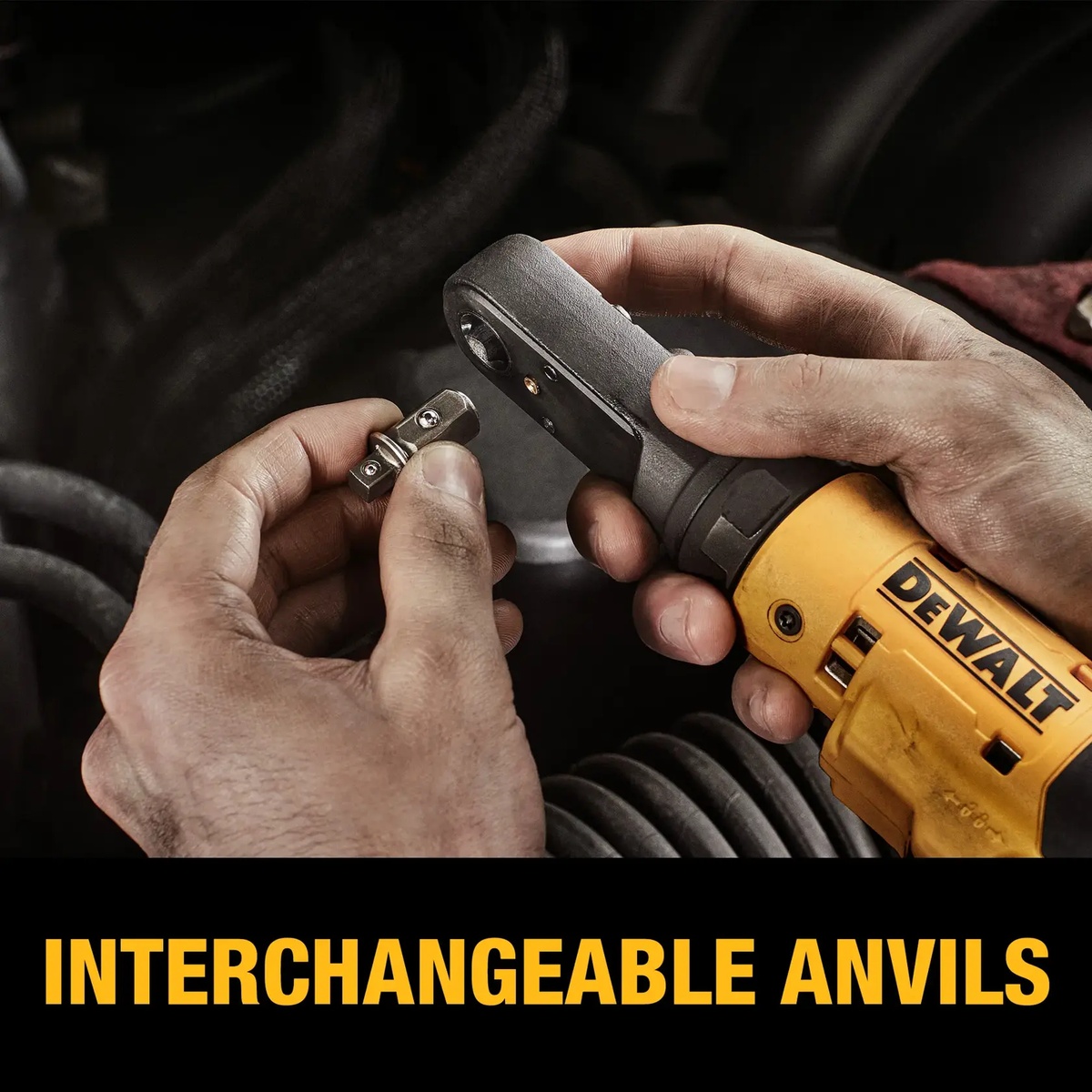 DeWALT DCF500B 12V MAX 3/8-in and 1/4-in brushless cordless sealed head ratchet with interchangeable anvil being installed by hand during automotive service work in a tight engine bay