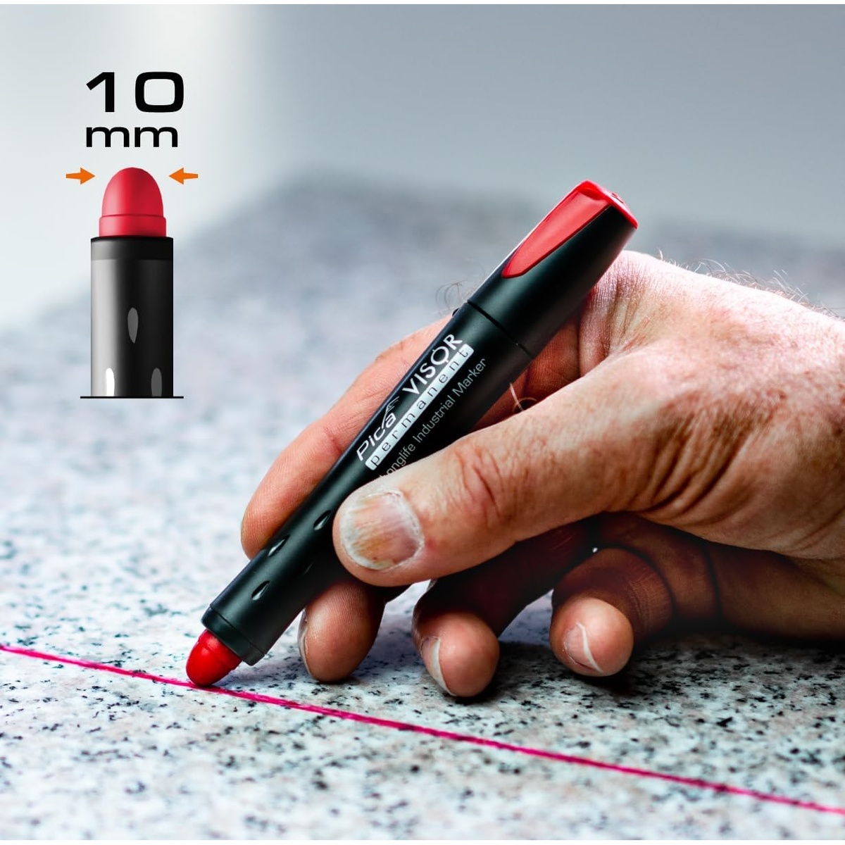 Pica 990/40 VISOR Luminescent Permanent Marker drawing a red line on a stone or granite surface for construction layout work